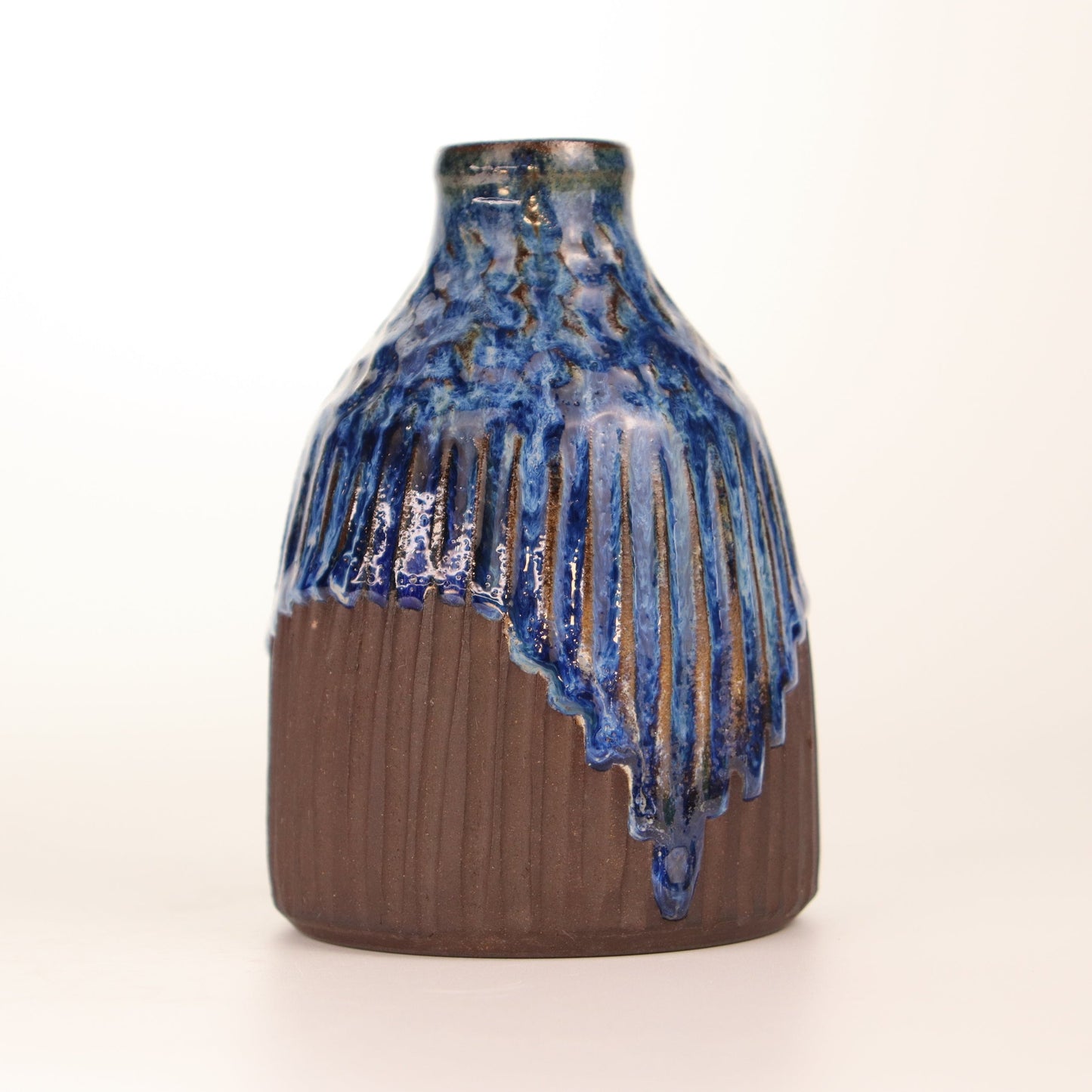 Handmade on the potters wheel this beautiful stoneware Bud Vase / Cruet stands 3 inches wide by 4.5 inches high. It comes with a spout to measure out the perfect amount of dressing. It also looks great holding a couple of flowers picked fresh from the garden. Rustic and beautiful sure to compliment any decor.